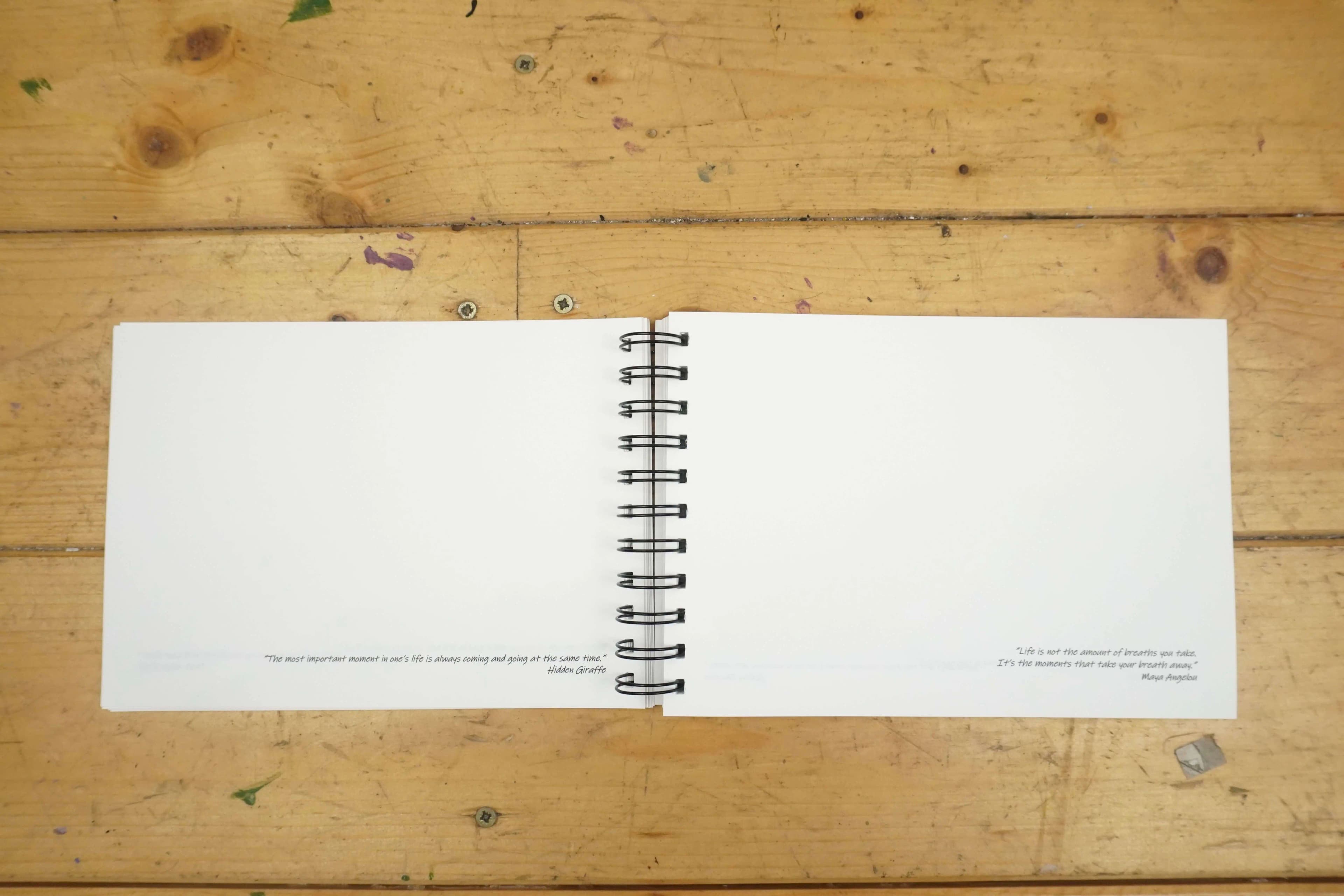 Open Hidden Giraffe Discovery Sketch Book with blank pages and inspirational quotes at the bottom.